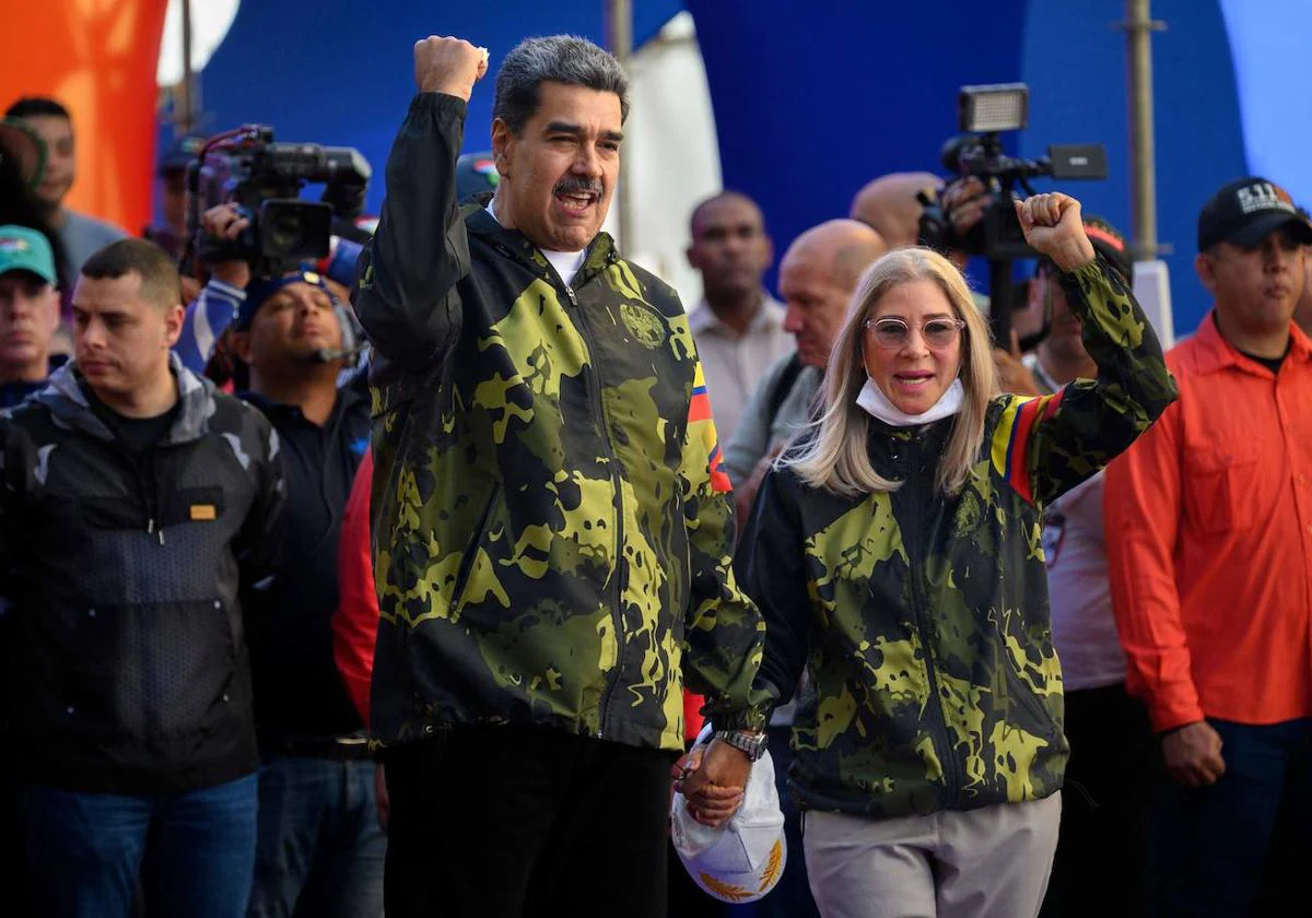 El presidente venezolano, Nicolás Maduro (izq.) y la primera dama Cilia Flores (der.), saludan a sus seguidores